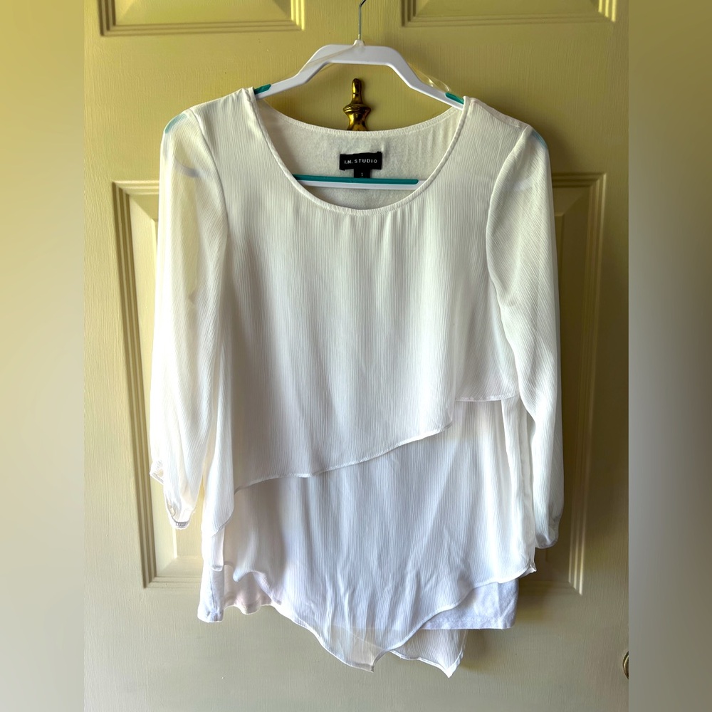 White, 3/4 sleeves, asymmetrical top. Excellent condition. Shear material.